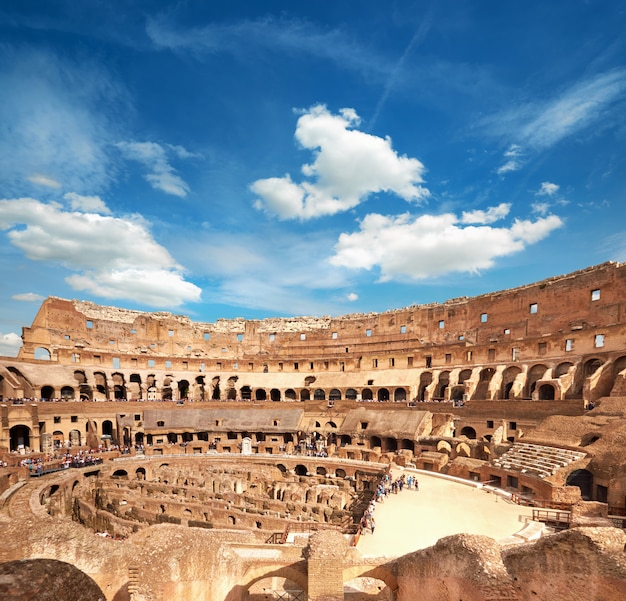 Inside of Colosseum Rome with blue white sky, Rome, Italy