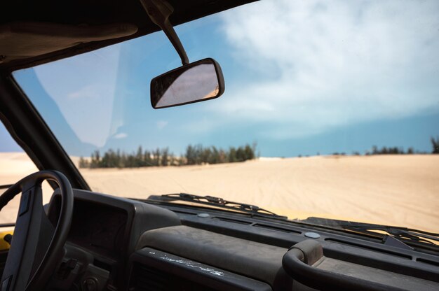 Inside of Four-wheel car driving in the sand dune