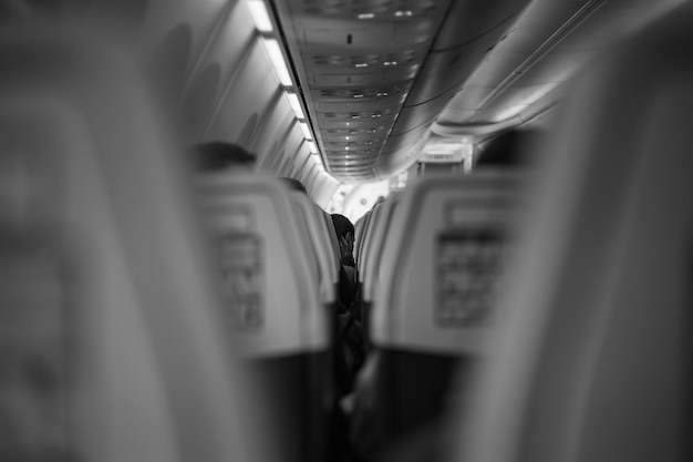 Inside the passenger plane inside the cabin in black and white