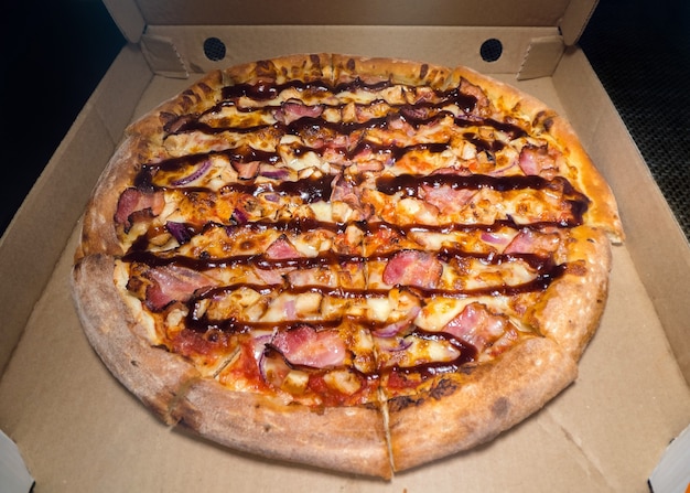 Inside of a Pizza box. Classic pizza in a cardboard box. Wide angle view from above. Pizza delivery, menu. Fast food, crusty dough