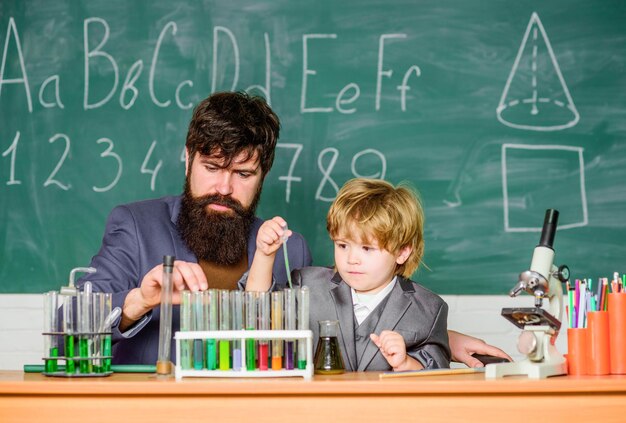 Inspiration Technology father and son at school teacher man with little boy School education Back to school laboratory research and development science camp Chemistry beaker experiment