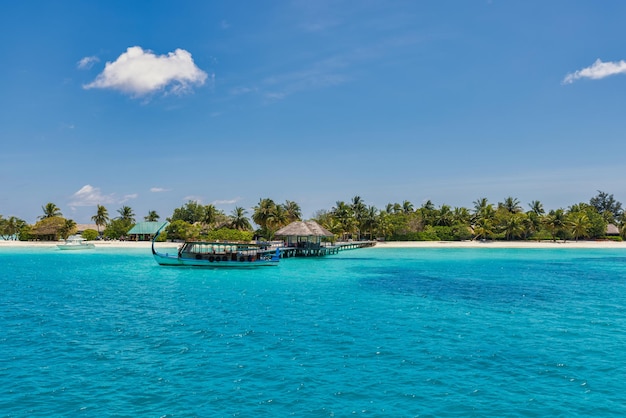 Inspirational Maldives beach design. Maldives traditional boat Dhoni and perfect blue sea lagoon bay