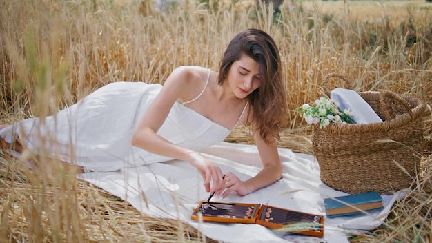 Inspired woman drawing nature laying at spikelets field lady relaxing blanket