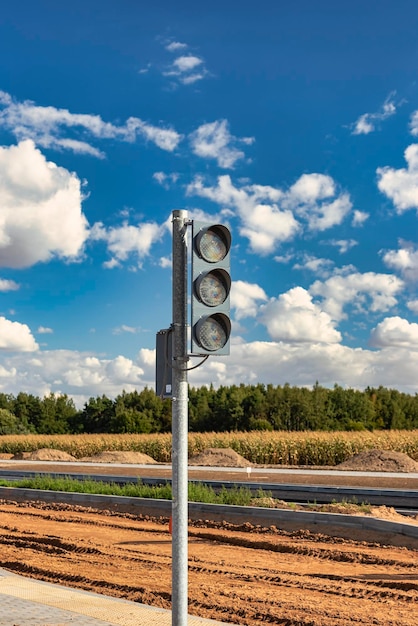 Installation of group traffic lights during the construction of a new traffic intersection and a pedestrian crossing at the edge of the city