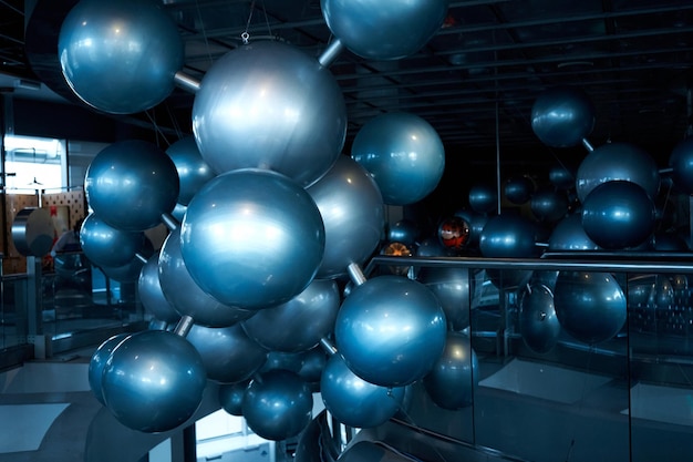 Installation of stylish connected silver balls decoration modern interior in science museum