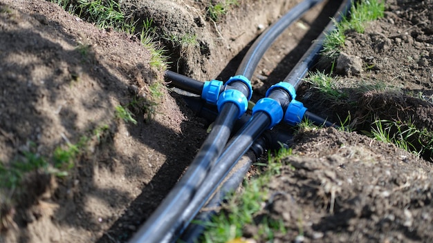 Installed PVC water pipes in trench at summer cottage