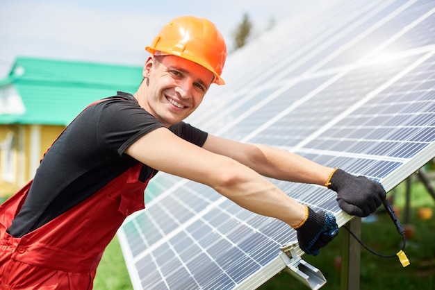 Installer inspecting solar energy on a plot near the house