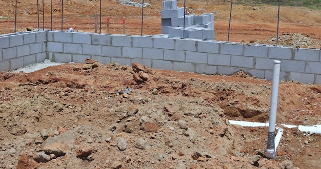 Installing sewer and water pipes in the ground under the foundation of a new residential construction home