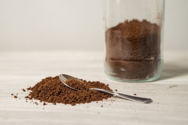 Instant coffee granules scattered brown close up.