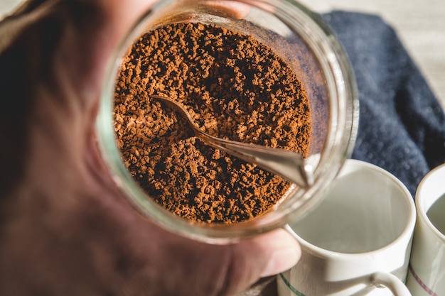 Instant coffee granules scattered brown close up.