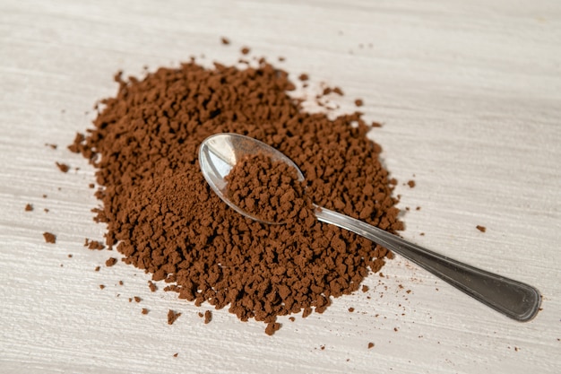 Instant coffee granules scattered brown close up.