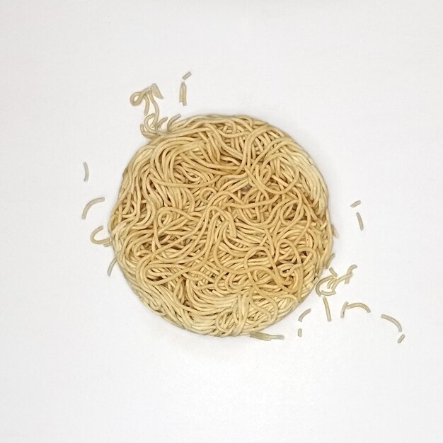 Photo instant dry raw uncooked ramen cup noodle on white background