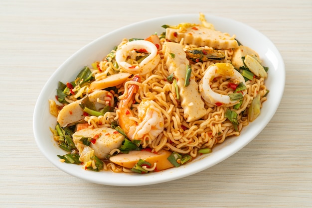 Instant noodle spicy salad with mixed meats - Asian food style