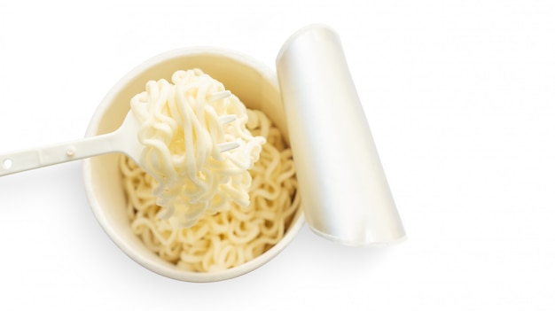 Instant noodles cup and a fork on a white background.