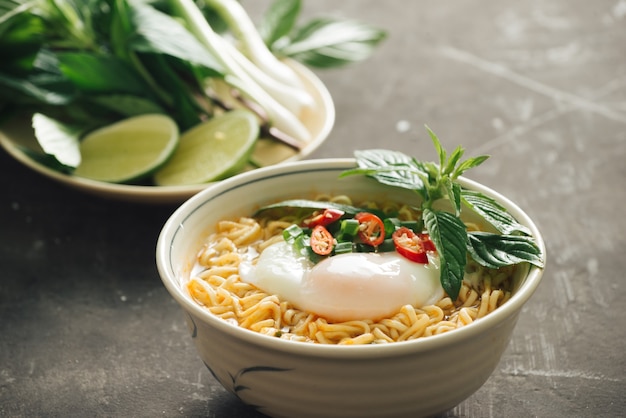 Instant noodles soup put egg and vegetables