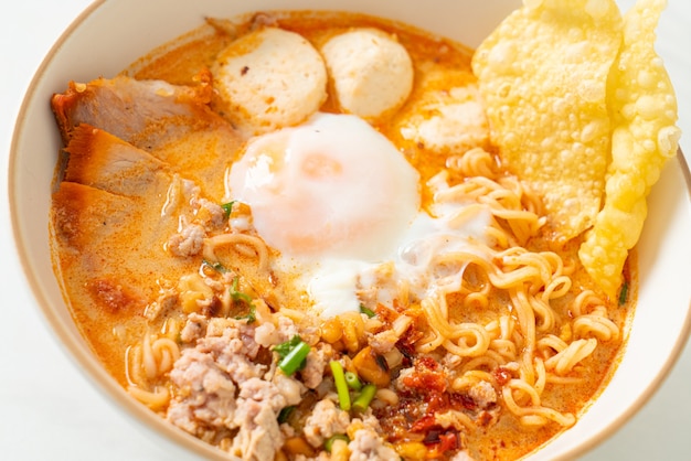 instant noodles with pork and meatballs in spicy soup or Tom Yum Noodles in Asian style