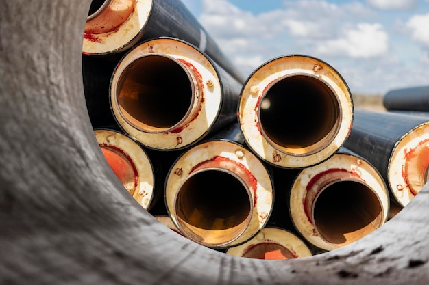 Insulated pipe Large metal pipes with a plastic sheath at a construction site Modern pipeline for supplying hot water and heating to a residential area Closeup