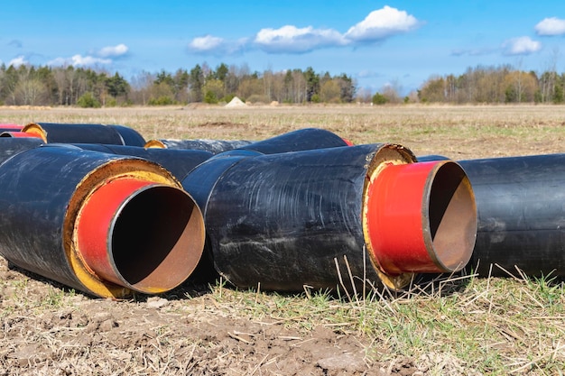 Insulated pipe Large metal pipes with a plastic sheath at a construction site Modern pipeline for supplying hot water and heating to a residential area