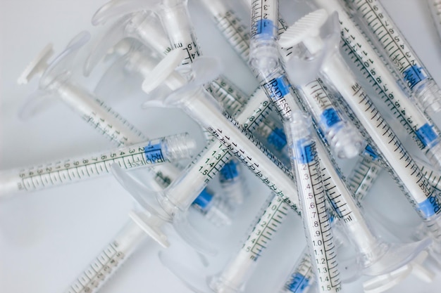 Insulin syringes without plastic needles lie on a white background medical waste