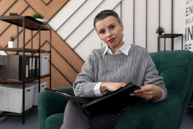 Insurance agent woman with folders for documents in the office