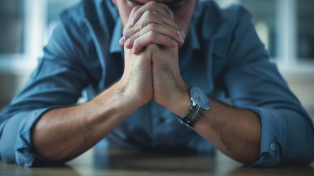 An insurance agent39s tense shoulders and clasped hands on a desk reflecting a moment of contemplation and concern