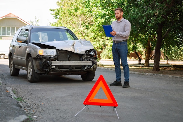 Insurer inspects car and calculates damage after car accident man auto insurance agent inspect