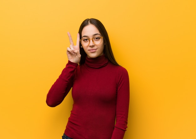 Intellectual young girl fun and happy doing a gesture of victory