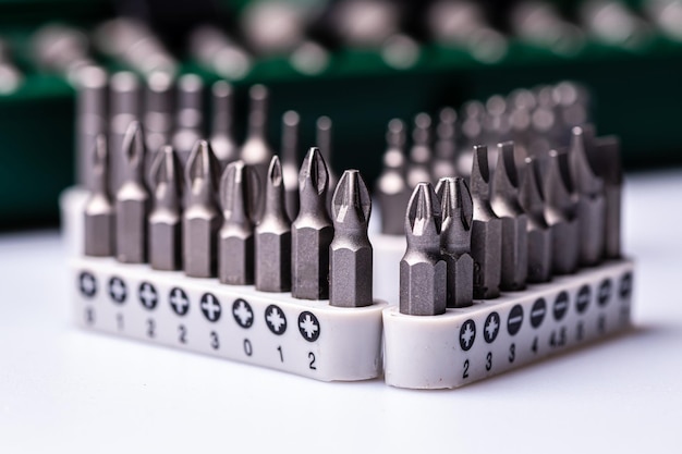 Interchangeable screwdriver bit set isolated on white selective focus dof closeup