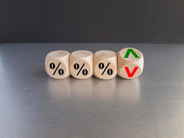 Photo interest rates symbol wooden cubes with the direction of an arrow symbolizing