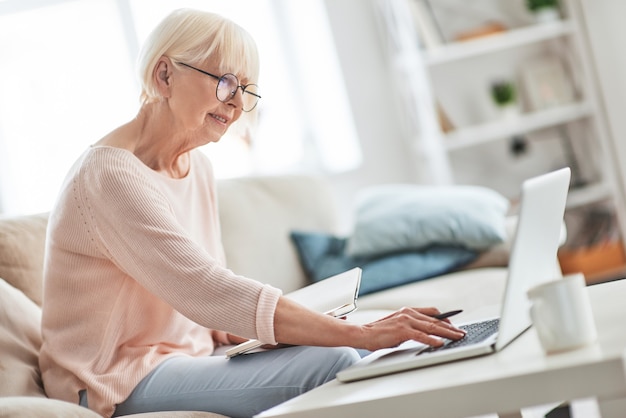 Interesting... Beautiful senior woman writing something down 