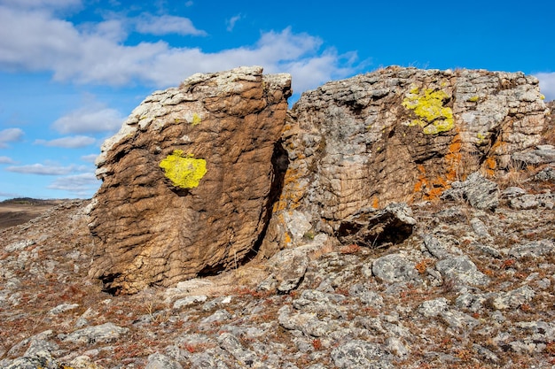 An interesting stone with layers with an interesting structure Dilapidated stones Blue sky Horizontal