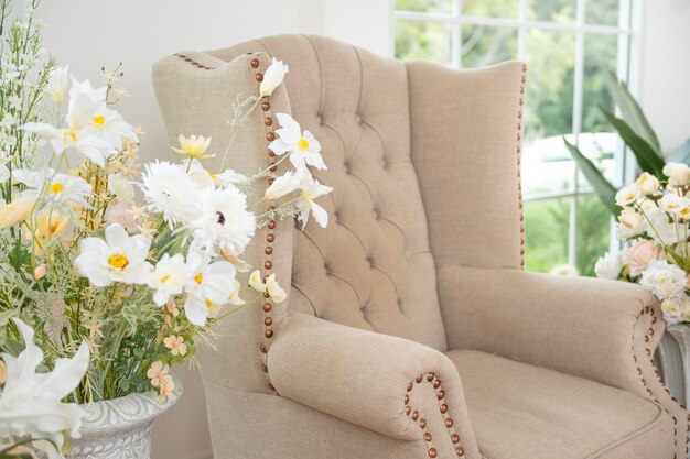 Photo interior of armchair decorated with beautiful flowers for wedding ceremony