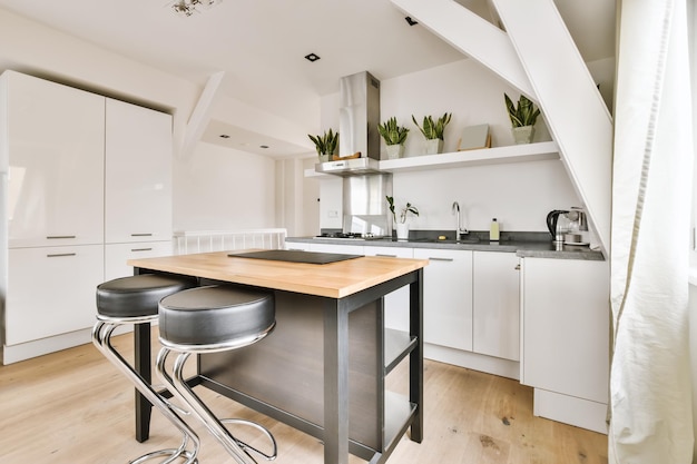 The interior of an attractive kitchen with lots of pots of flowers