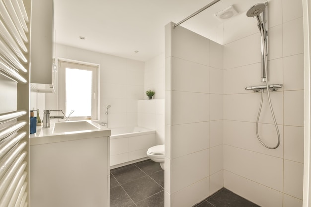 The interior of a bathroom decorated with white and black tiles