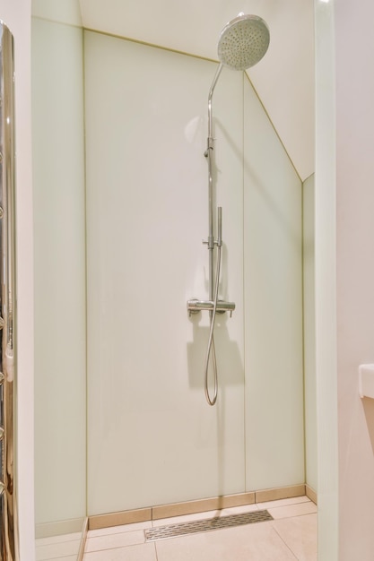 The interior of a bathroom with a glazed shower cabin in a modern house