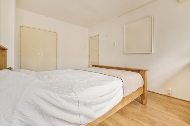 The interior of a bedroom with a wooden bed and a wardrobe in a modern apartment