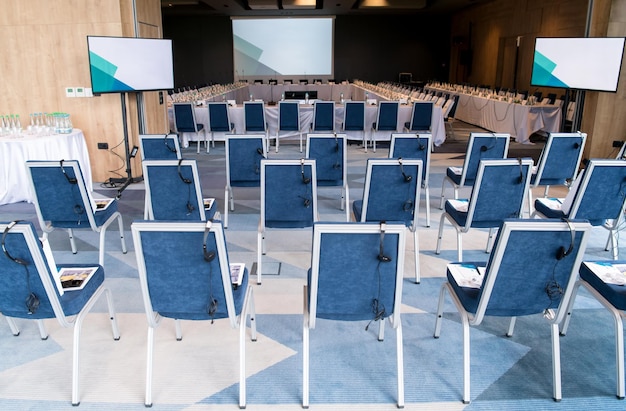 Photo interior of big modern conference room before starting a business seminar