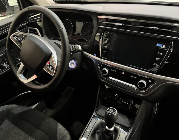 Interior of the car interior. Steering wheel, dashboard, computer screen, manual transmission