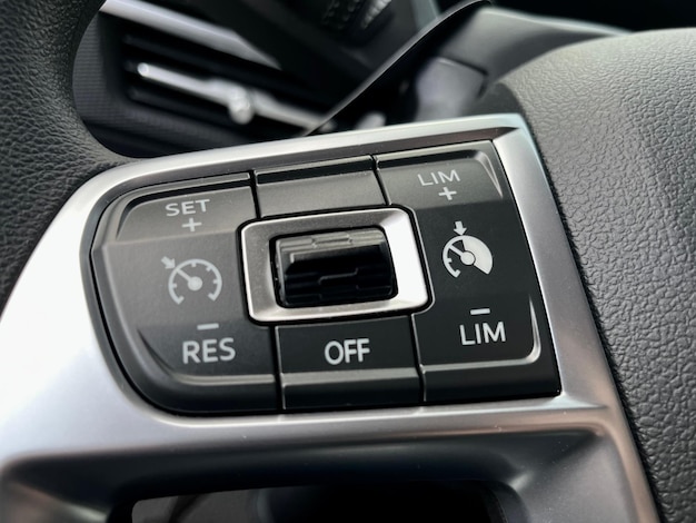 Interior of the car with cruise control buttons, voice communication on the steering wheel