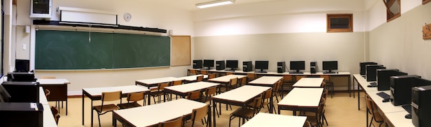 Interior of a classroom with row of computers