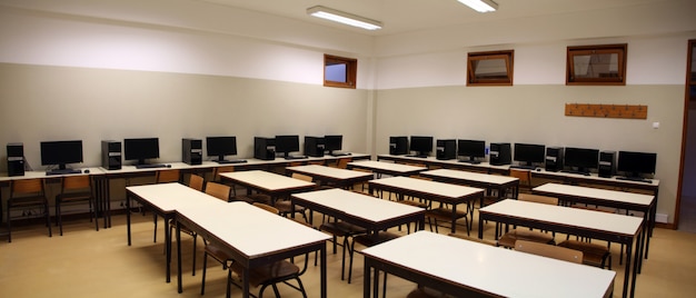 Interior of a classroom with row of computers