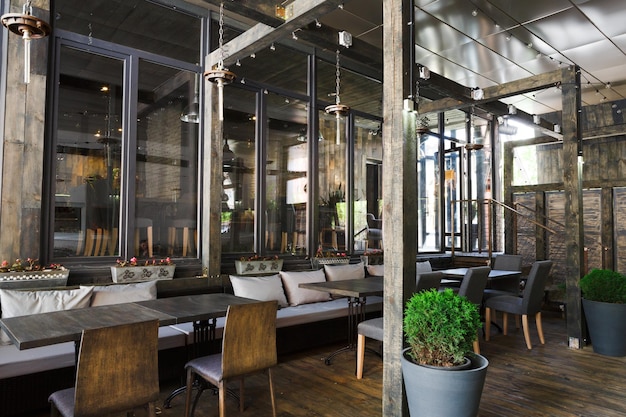 Interior of cozy restaurant. Contemporary design in loft style, modern dining place and bar counter, copy space