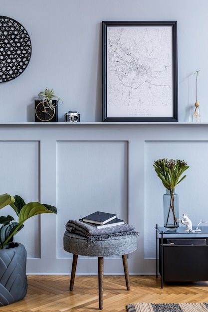 Interior design of scandinavian living room with black poster map, grey stool, black coffee table, plants, flowers in vase, decoration, carpet, book and elegant personal accessories.