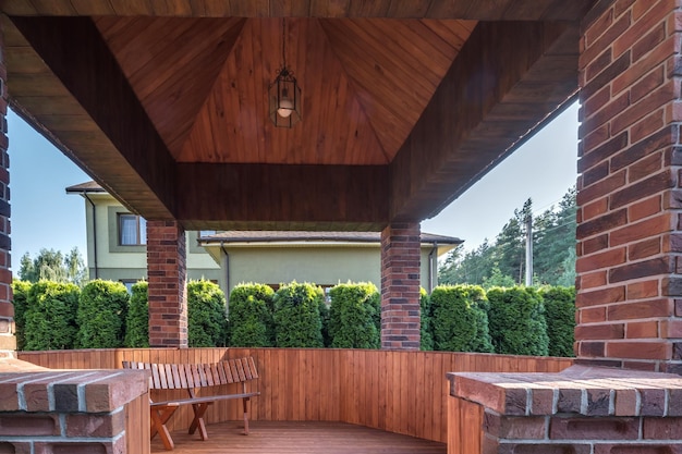 Interior of empty hall veranda in wooden village vacation home with garden chairs