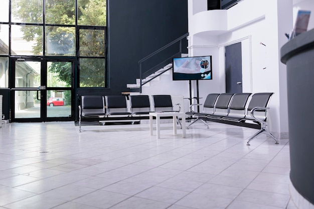 interior of empty hospital lobby with big windows waiting for patients. Modern healthcare facility, professional treatment room. Waiting area of emergency hospital reception