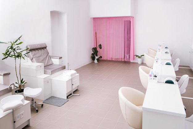 Interior of empty modern nail salon. Work places for masters of manicure