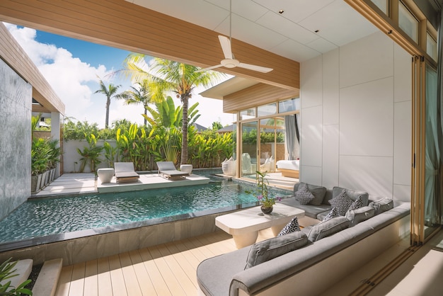 Interior, exterior design of luxury pool villa, house, home feature living room with swimming pool