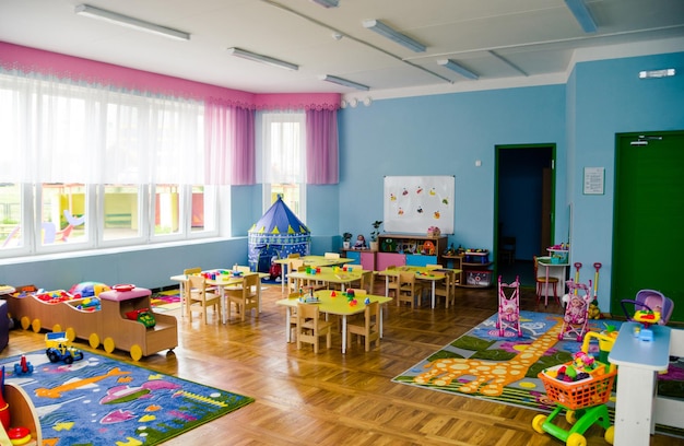 The interior of a group in a kindergarten with a lot of toys educational games and bright furniture