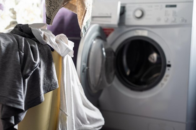 The interior of the home laundry room, next to the washing machine stand baskets for dirty clothes to segregate filled with things