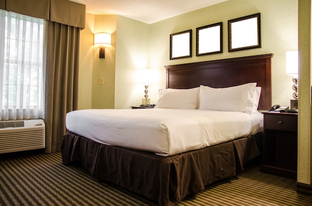 Interior hotel bedroom with white bed